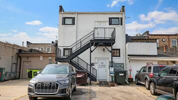 A building with a staircase leading to a door marked "731".