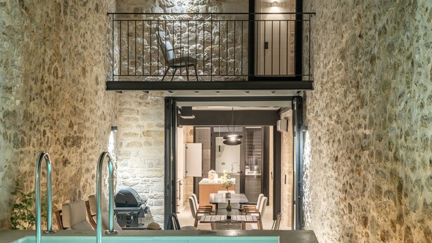 A stone-walled interior with a pool, dining area, and a balcony. - Dianthus Residence, Heated Pool & in-pool Whirlpool (Adele)