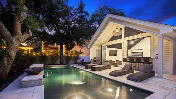 A modern outdoor pool area with lounge chairs and a covered patio. - THE PEARL!  7bd/7ba IOP Home Private POOL & Ocean VIEWS! (Isle Of Palms)