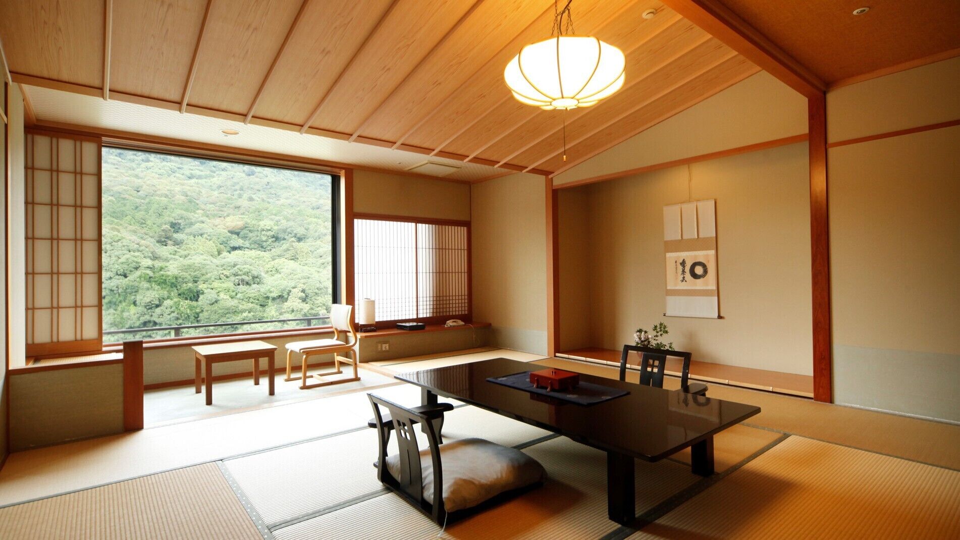 A traditional Japanese room with tatami flooring, a low table, and sliding doors.