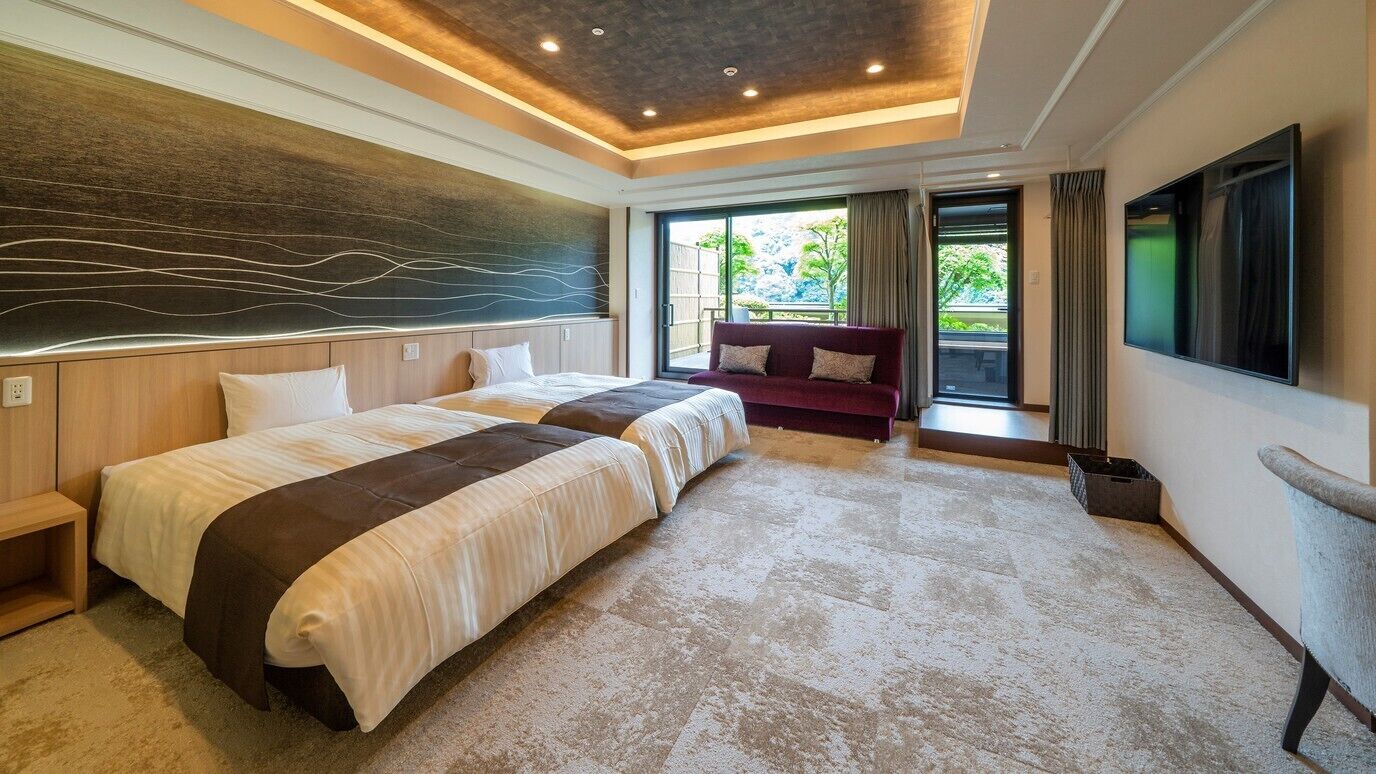 A hotel room with two beds, a large window, a flat-screen TV, and a modern ceiling design.