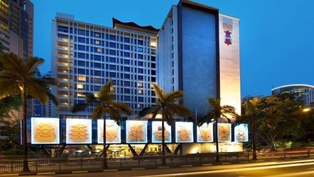 A hotel with a modern design, featuring a prominent vertical structure and multiple balconies. - Hotel Royal Singapore (Singapore)