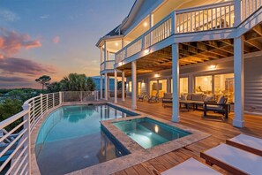 A large house with a swimming pool, outdoor seating, and a balcony. - Luxury Direct Oceanfront NEW Private Elevated Pool and Spa! Limo Golf Cart Included (Fripp Island)