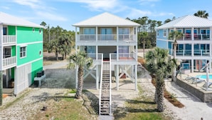 A beachfront property with a two-story building, a covered deck, and a swimming pool. - Amethyst Cove (Port St. Joe)