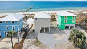 A beachfront property with three houses, a dock, and a clear view of the ocean. - Amethyst Cove (Port St. Joe)