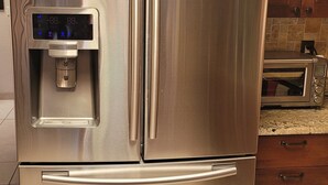 A stainless steel refrigerator with a built-in water dispenser and a side-by-side freezer. - Charming, convenient and comfortable!! (Albuquerque)