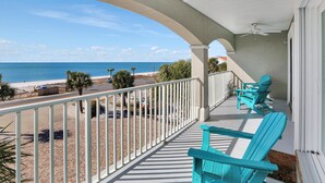 A balcony with turquoise chairs, a view of the beach, and a white railing. - Beach Destiny (Port St. Joe)