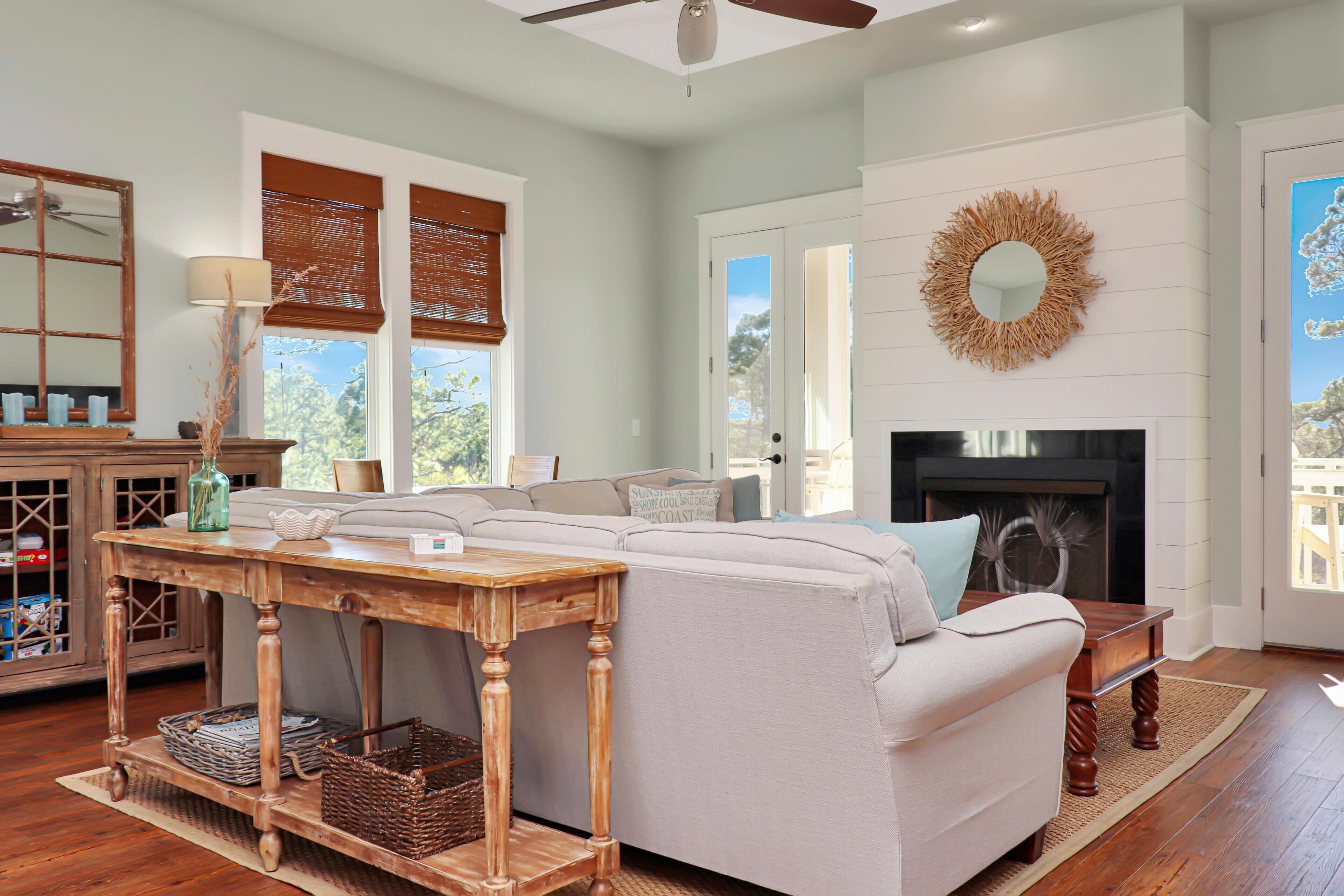 A living room with a sofa, wooden table, and a fireplace.