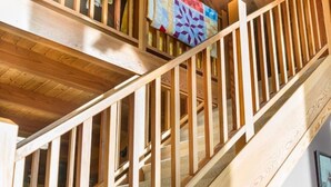 A wooden staircase with a railing, leading to an upper floor. - A Sauratown Mountain Getaway (Pinnacle)