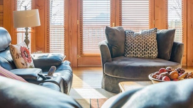 A cozy living room with a large window, a fireplace, and a comfortable seating area. - A Sauratown Mountain Getaway (Pinnacle)