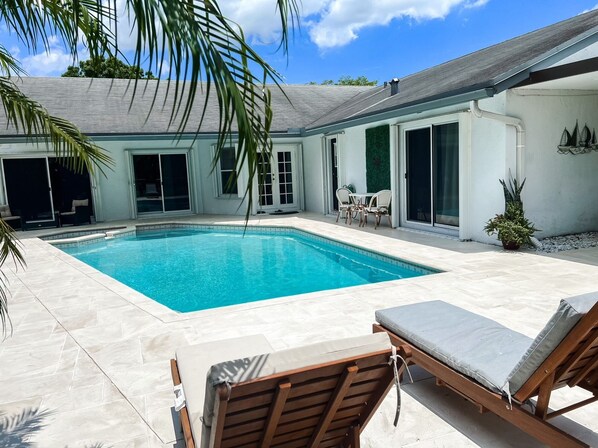 Outdoor pool, a heated pool, sun loungers