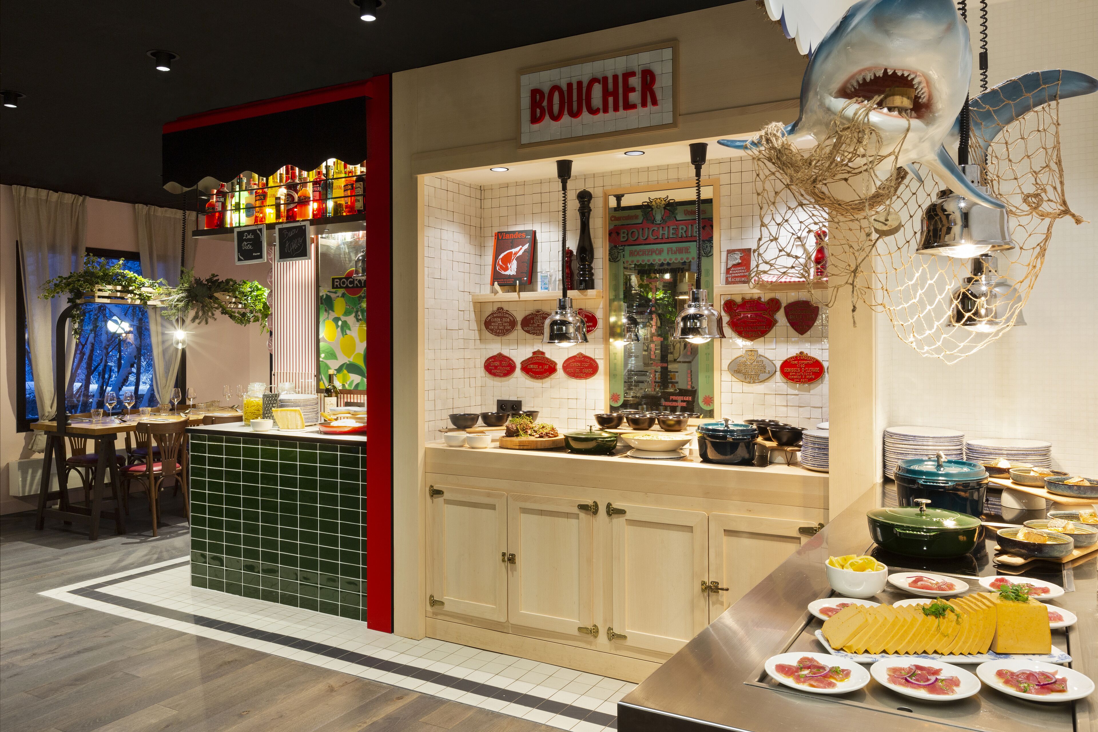 A restaurant with a seafood theme, featuring a sign that reads "BOUCHER" and a variety of seafood dishes displayed on the counter.