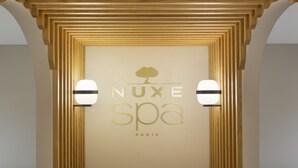A spa sign with 'NUXE spa PARIS' and a tree logo.