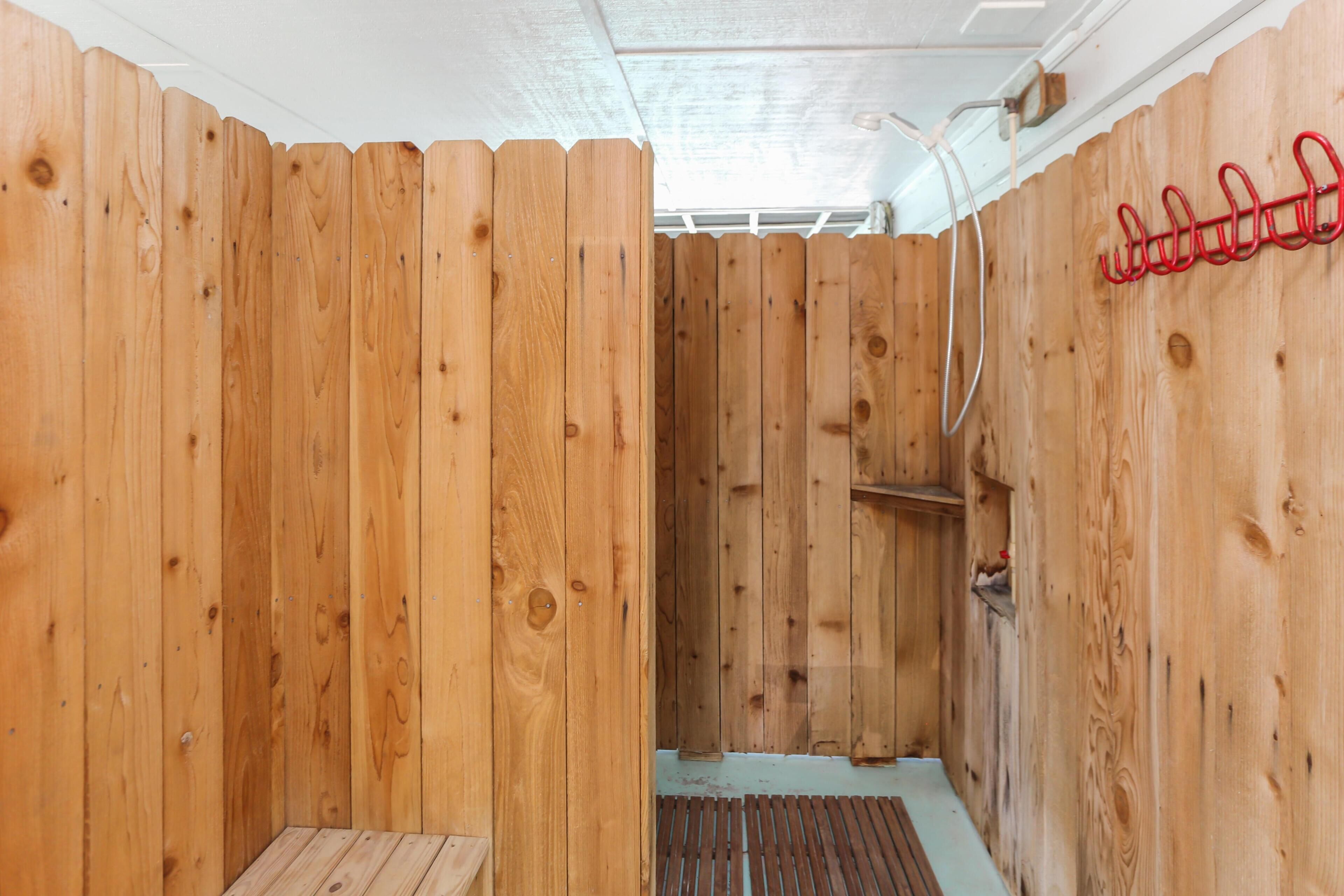 A wooden sauna with a bench and a shelf.