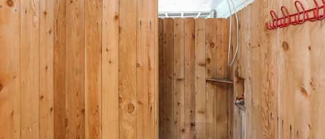 A wooden sauna with a bench and a shelf.