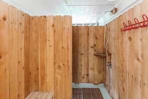 A wooden sauna with a bench and a shelf.