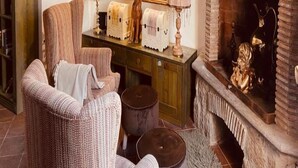 A cozy living room with a fireplace, a painting, and a dog statue. - Townhome (Viterbo)