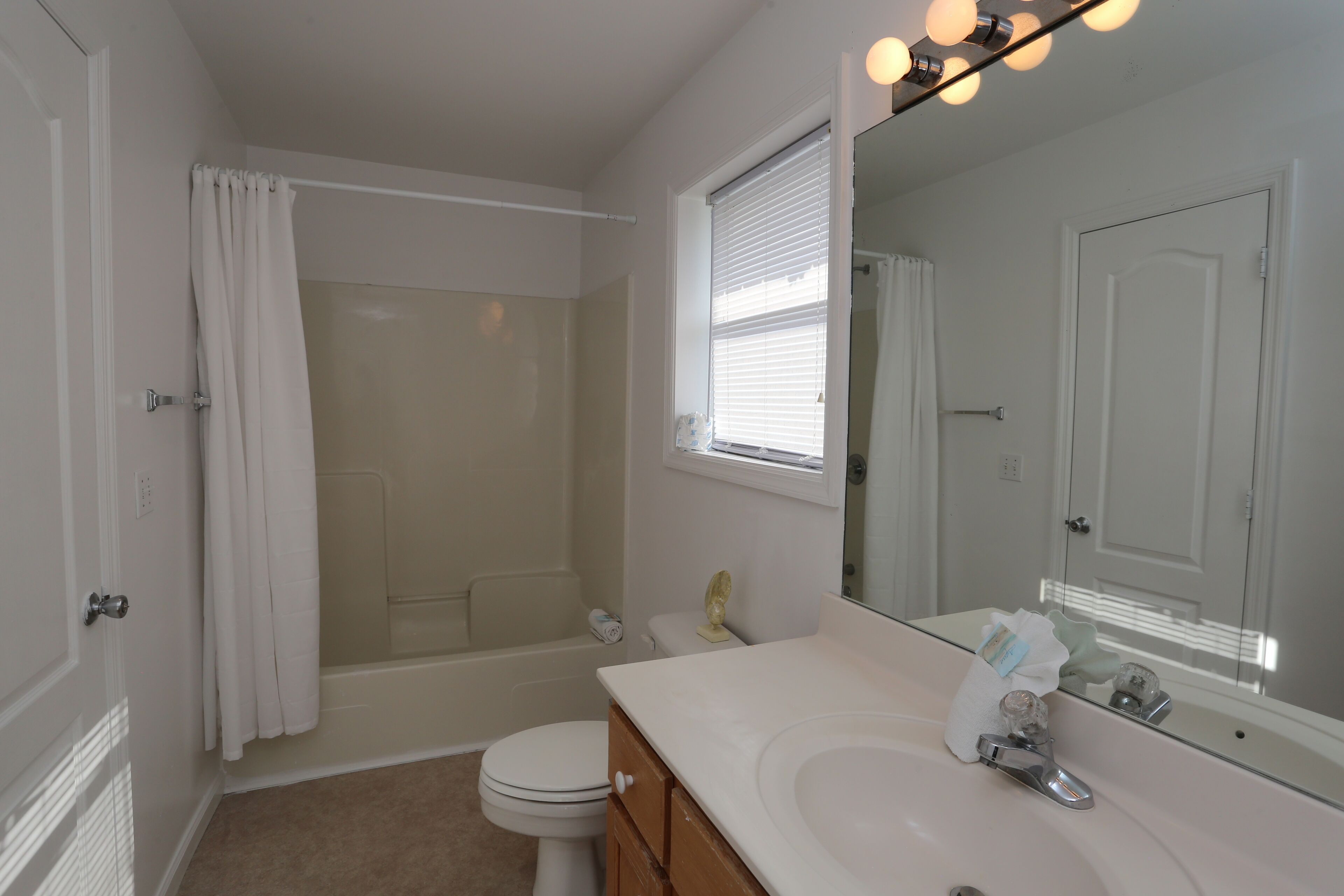A bathroom with a bathtub, toilet, and sink.