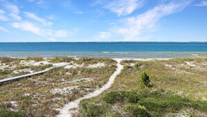 A beach path leading to the ocean with a clear sky. - Flamingo Dunes (Port St. Joe)