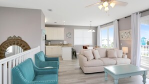 A living room with a light blue sofa, a white sofa, and a light blue coffee table. - Pearly Shells (Port St. Joe)