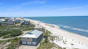 A coastal property with a beach view, multiple buildings, and a clear sky. - Paradise By The Gulf (Port St. Joe)