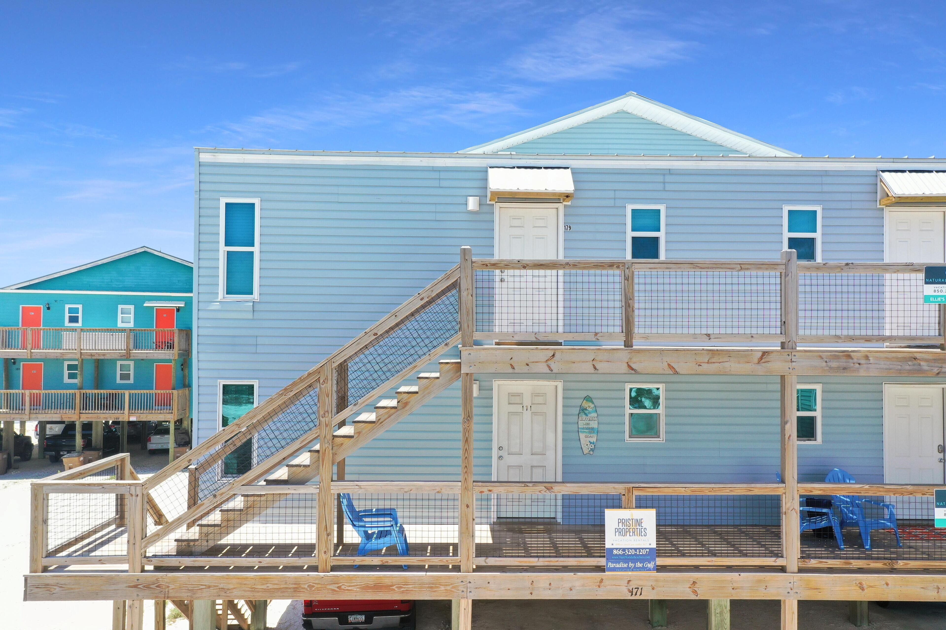 A two-story building with a wooden deck and a sign indicating it is a private property.