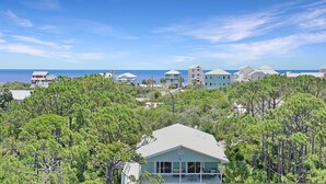 A coastal residential area with houses surrounded by dense pine trees. - Hideaway Bay (Port St. Joe)
