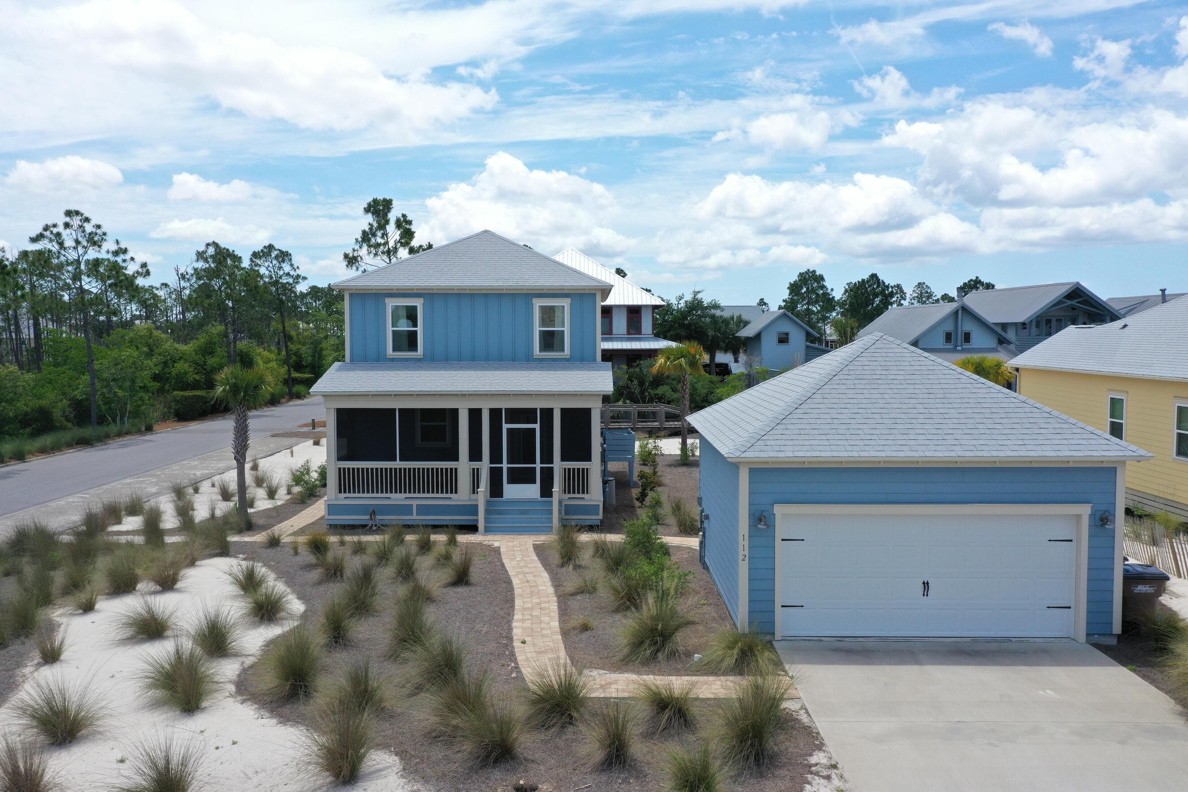 A two-story house with a covered porch and a garage.