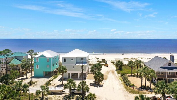 A coastal residential area with houses, a beach, and a clear sky. - Sweet Destiny (Port St. Joe)