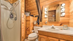 A wooden bathroom with a shower, toilet, sink, and vanity. - Irwin A-Frame Cabin w/ Deck & Mountain Views! (Irwin)