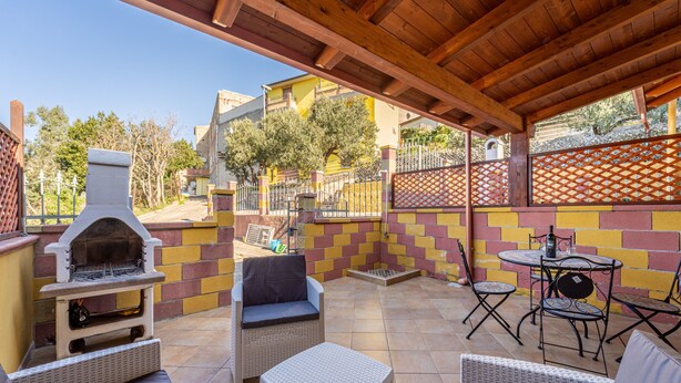 An outdoor patio with wicker furniture, a barbecue grill, and a tiled floor. - Holiday Home "Casa Barbara" with Air Conditioning and WiFi (Nebida)