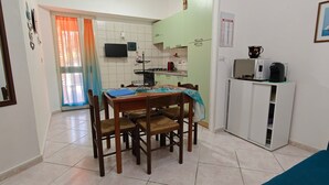A compact kitchen with a dining area, a small refrigerator, and a television. - Holiday Home "Casa Barbara" with Air Conditioning and WiFi (Nebida)