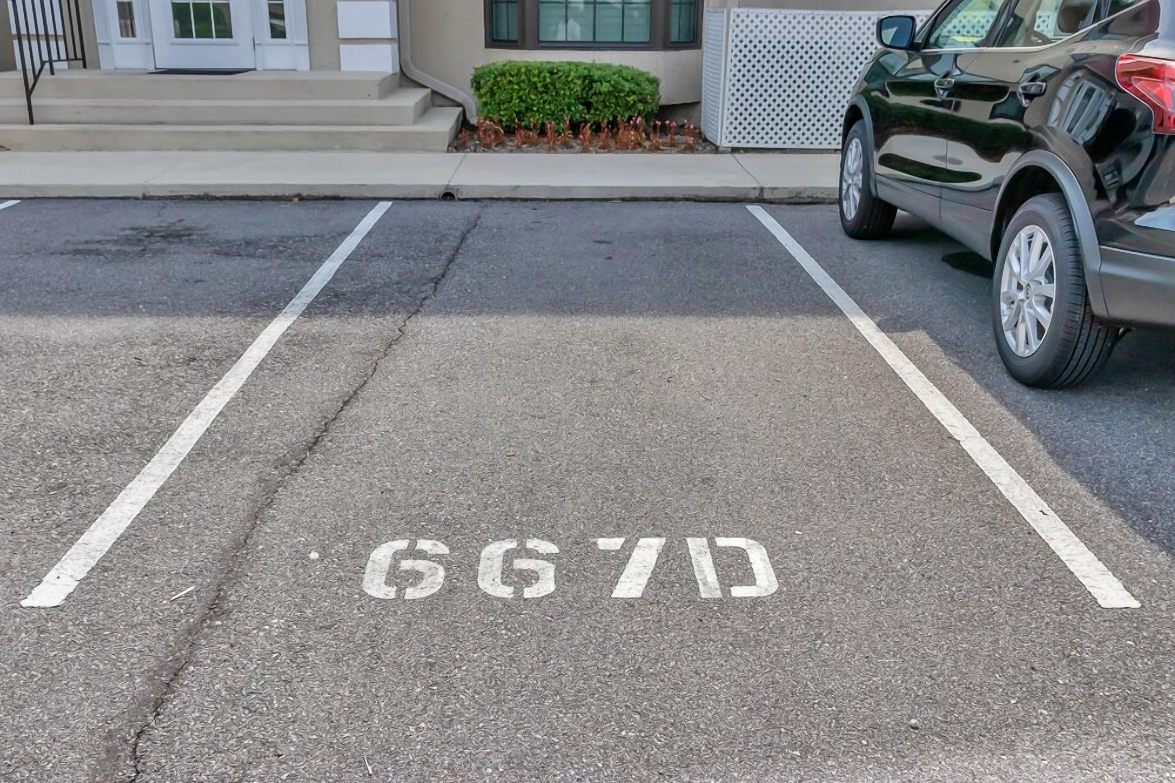 A parking space with the number 667D painted on the ground.