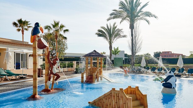 A pool area with water features, palm trees, and lounge chairs. - Protur Badí­a Park Aparthotel (Sant Llorenc des Cardassar)