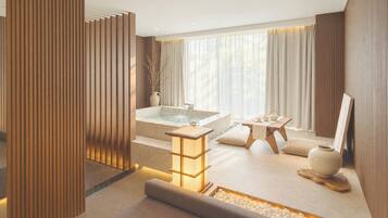 A modern spa room with a hot tub, seating area, and a decorative water feature.
