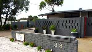 A modern building with a brick facade, numbered 38, and a sign indicating it is an investigator's bench. - Fresh, relaxed 2 bedroom apartment, only 1.9kms from the beach, close to shops (Kingscote)