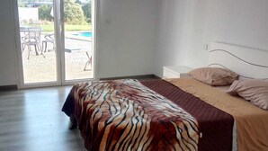 A bedroom with a bed, a sliding glass door leading to an outdoor area, and a view of the outdoors. - VILLA FOR 6 PEOPLE, POOL AND BBQ (Mioma)