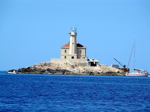 A lighthouse on a rocky island with a clear blue sky. - A1- apt With Terrace, Just 3 min Walk to the Beach (Rogoznica)