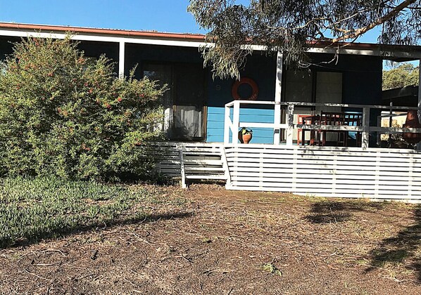 A building with a blue exterior and a white fence.