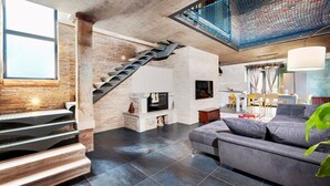 A modern living room with a fireplace, a staircase, and a dining area. - Modern Villa Baraka with a pool (Kanfanar)