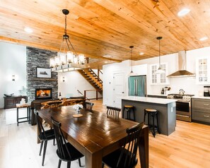 Enjoy cooking in this kitchen with a large island, oven, and stainless steel refrigerator.