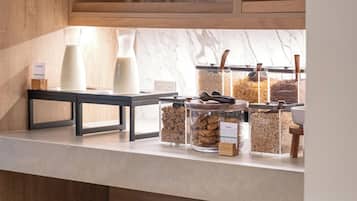 A kitchen counter with various food items and kitchenware.