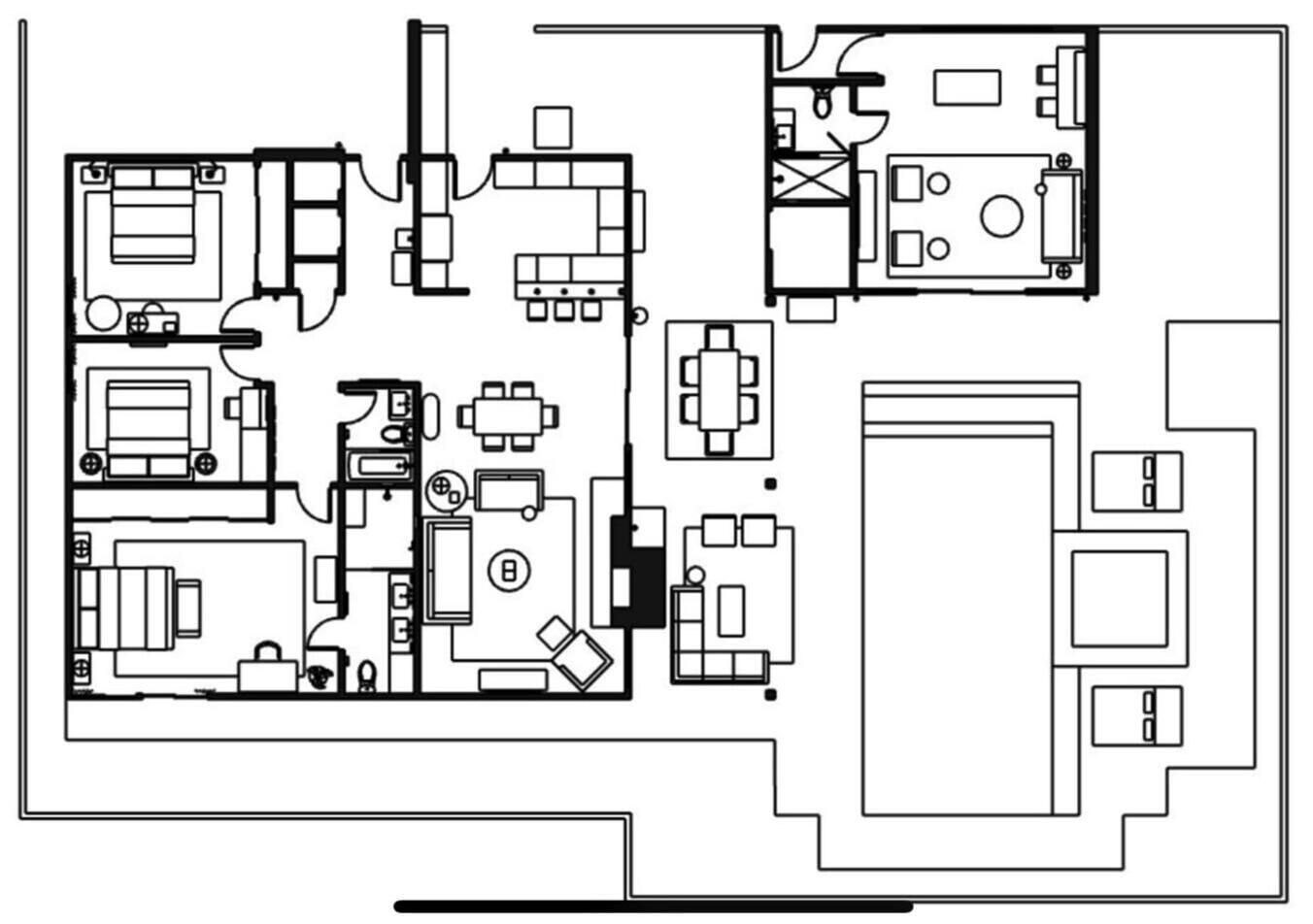 A floor plan with multiple rooms, including a large living area, a dining room, and several bedrooms.
