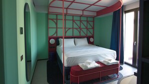 A room with a bed under a red canopy labeled "TROPICANA," a round mirror, and a window with curtains. - Tropicana Club: No conventional! (Rimini)