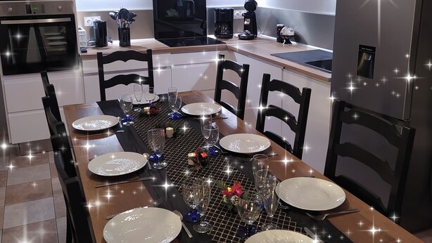 A modern kitchen with a dining area set for a meal.