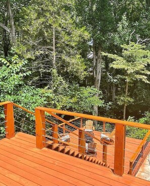 Step out onto the deck surrounded by lush greenery and take in the serene forest views.
