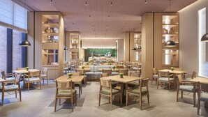 A spacious restaurant with high ceilings, wooden furniture, and a central kitchen area. - Hyatt Place Jingdezhen Taoxichuan (Jingdezhen)