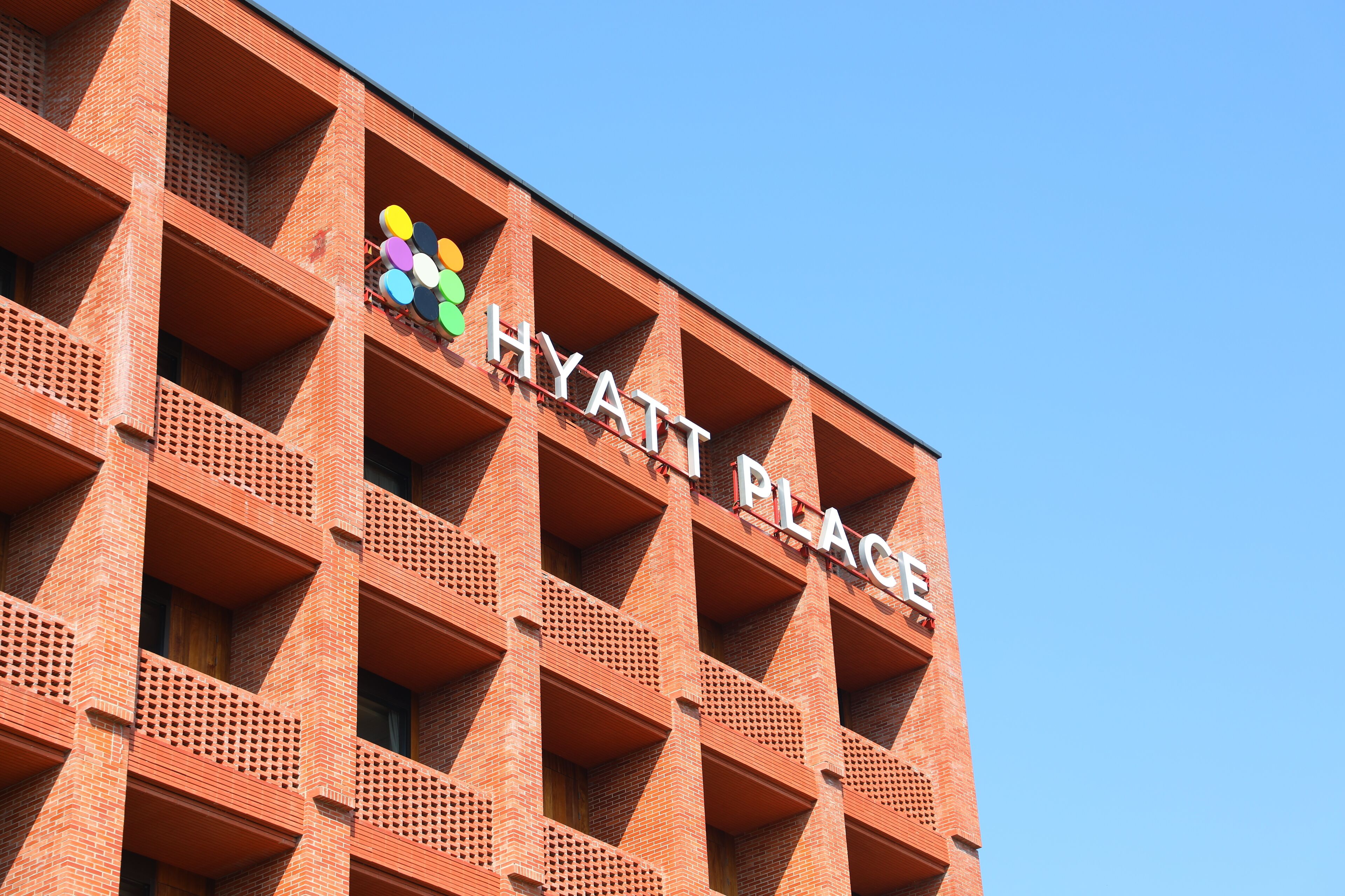 A brick building with a sign reading "HYATT PLACE".