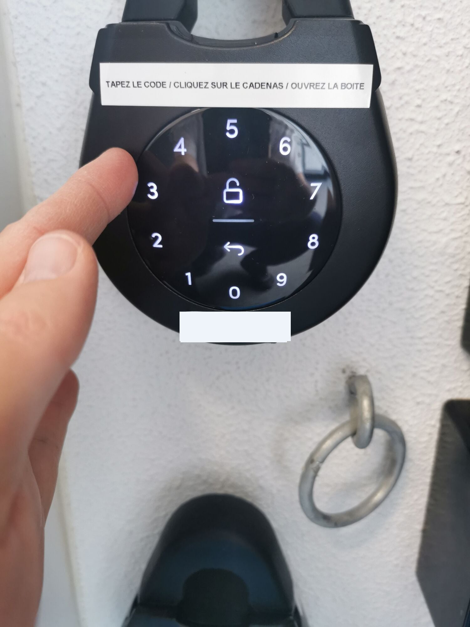 A keypad with a lock symbol and a hand pressing the number 1.