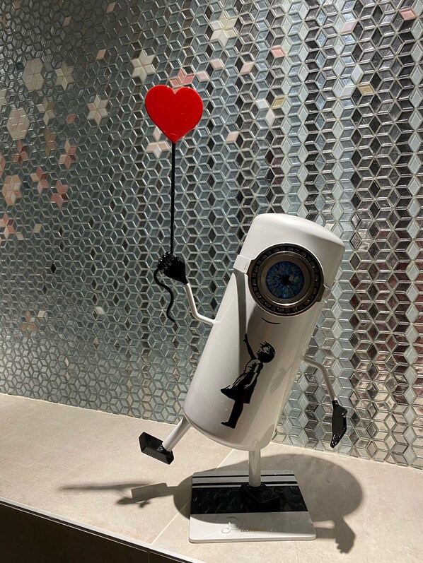 A security camera with a cartoon character design, mounted on a stand.